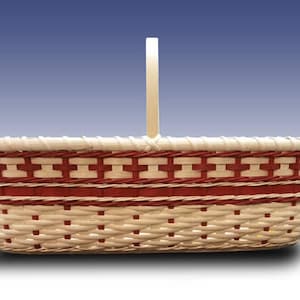 May include: A white wicker basket with a red and white woven design and a wooden handle.