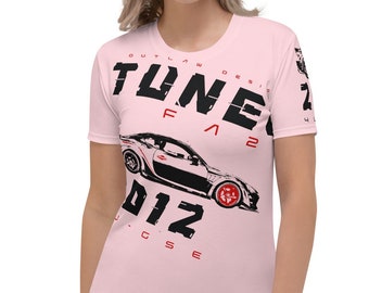 May include: A pink women's t-shirt with a black and white graphic of a car and the text "TUNER FA2 012" in black and red.