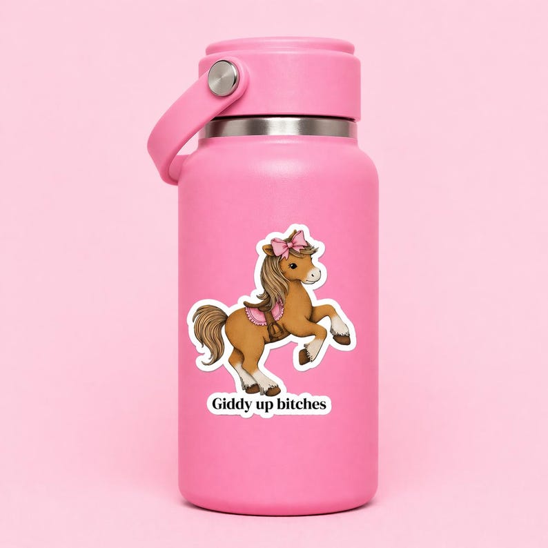 Funny horse sticker displayed on a pink water bottle, showing a charming pony with a pink bow and the phrase “Giddy up bitches.” A perfect horse lover gift, this durable vinyl sticker is ideal for personalizing water bottles, tumblers, and everyday accessories with a bold, humorous vibe.