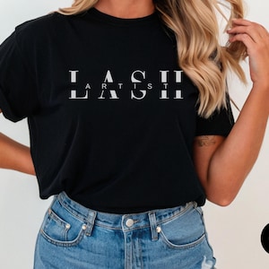 May include: Black t-shirt with the text "LASH ARTIST" in white lettering.