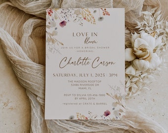 May include: A bridal shower invitation with a watercolor floral design. The invitation reads "Love in Bloom" and includes the bride's name, Charlotte Carson, the date and time of the shower, and the location. The invitation also includes the RSVP information and the registry information.