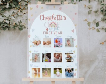 Può includere: Un poster grigio chiaro con un arcobaleno e il testo "Charlotte's One Derful First Year". Il poster ha 12 slot per foto per le foto del primo anno di un bambino.