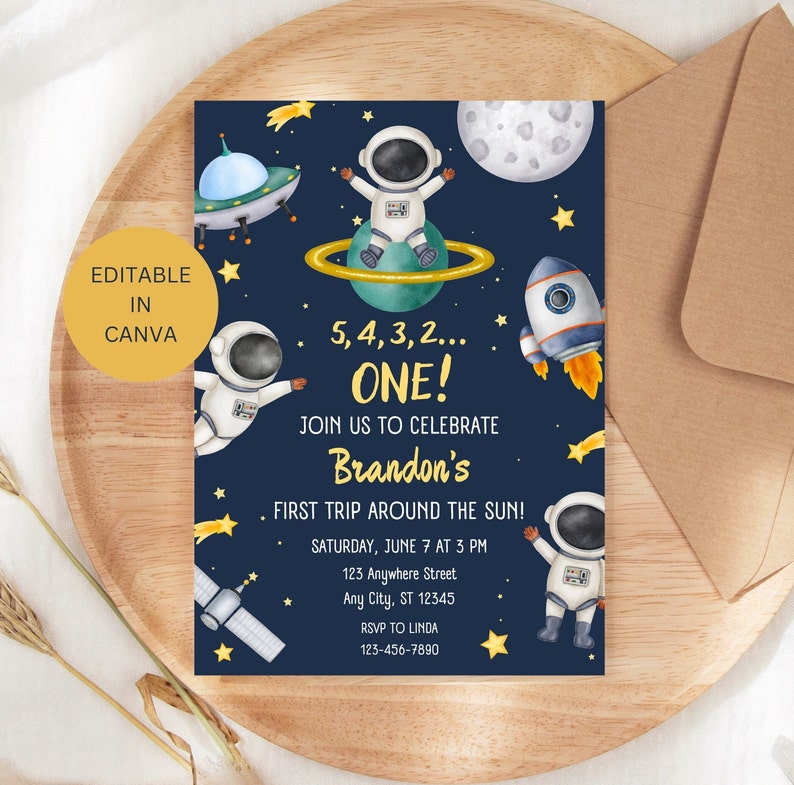 May include: A blue and gold space-themed first birthday party invitation with an astronaut, rocket, stars, and planets. The invitation says "5, 4, 3, 2... ONE! Join us to celebrate Brandon's First Trip Around the Sun!" with the date, time, address, and RSVP information.