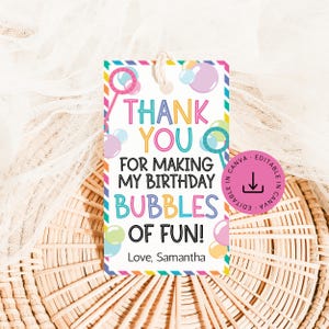 May include: A colorful gift tag with the text "THANK YOU FOR MAKING MY BIRTHDAY BUBBLES OF FUN!" in various colors. The tag features bubble wands and bubbles, with a string for hanging. The tag is designed for a birthday celebration.