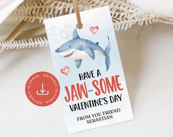 May include: A Valentine's Day gift tag featuring a cartoon shark with the text "Have a Jaw-some Valentine's Day." The tag includes red hearts and bubbles, with a Canva logo in the corner. It is attached to a brown string.