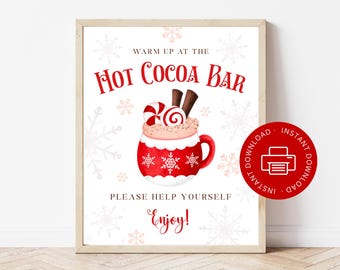 May include: A framed sign with the text "Warm up at the Hot Cocoa Bar" in red. The sign features a red mug of hot cocoa with whipped cream, candy, and chocolate sticks. The words "Please help yourself, Enjoy!" are also on the sign.