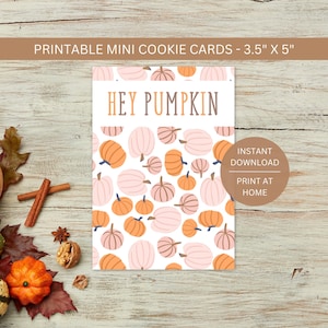 May include: A printable mini cookie card, 3.5" x 5", with a white background and a pattern of orange and pink pumpkins. The words "HEY PUMPKIN" are in orange and brown. The card also says "INSTANT DOWNLOAD" and "PRINT AT HOME".