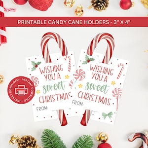 May include: Printable candy cane holders, 7.6 cm x 10.2 cm, with the text "Wishing You a Sweet Christmas." Each holder has a candy cane inserted. The design includes candy, stars, and holly. A red circle with a printer icon is in the corner.