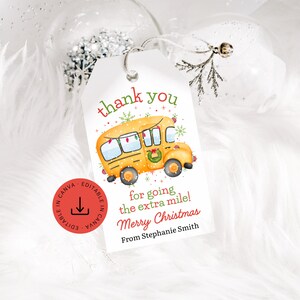 May include: A white gift tag with the words "thank you" in red and green. A yellow school bus with Christmas lights and a wreath is featured. The tag also says "for going the extra mile! Merry Christmas From Stephanie Smith."