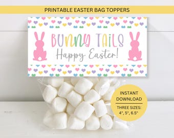 May include: A clear bag filled with white marshmallows, topped with a printable Easter bag topper. The topper features the text "BUNNY TAILS Happy Easter!" with pink bunny silhouettes and colorful hearts. The bag topper is available in three sizes: 4", 5", and 6.5".