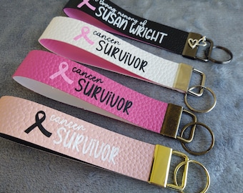 Personalized Breast Cancer Awareness Pink Ribbon Keychain Wristlets in Combinations of Pink, Black, and White Faux Leather and Vinyl.