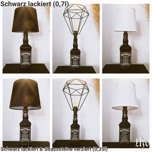 May include: Two Jack Daniel's whiskey bottles repurposed as table lamps. One lamp has a black lampshade and the other has a white lampshade. Both lamps have a geometric wire cage shade. The text "Schwarz lackiert (0,71)" appears at the top of the image. The text "Schwarz lackiert & Strasssteine verziert (0,351)" appears at the bottom of the image.