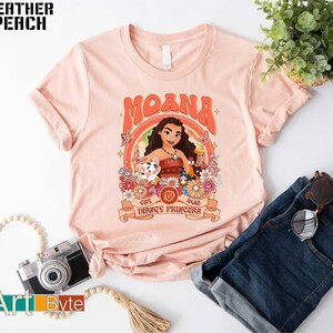 a pink shirt with a picture of moan on it