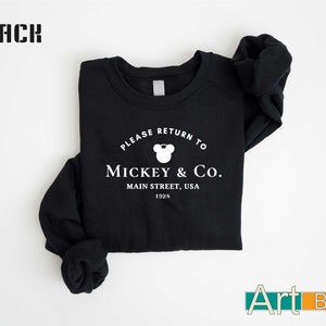 a black shirt with mickey and co on it