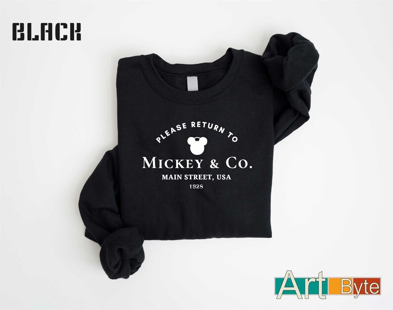 a black shirt with mickey and co on it