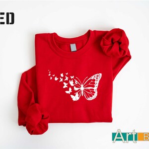 a red shirt with a white butterfly on it