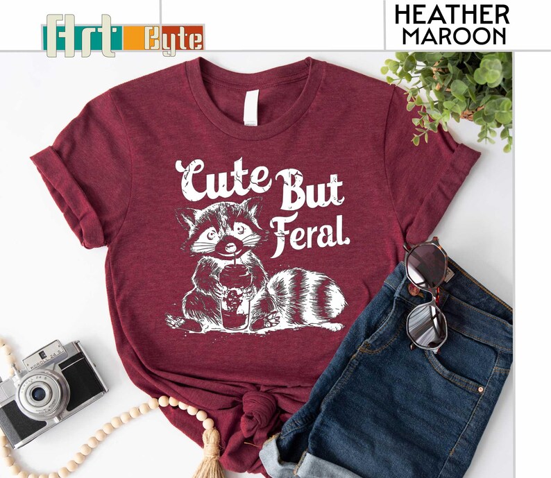 a t - shirt with a raccoon saying cute but fel