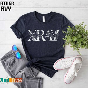 a t - shirt with the word xray on it next to a pair of