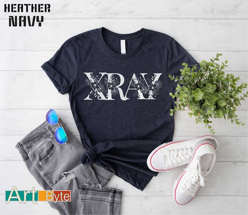 a t - shirt with the word xray on it next to a pair of