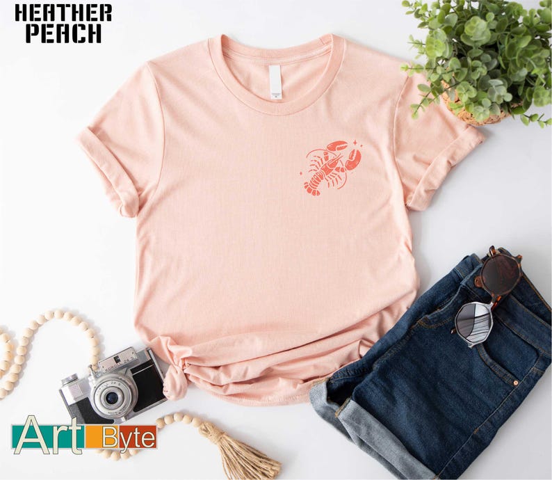 a pink t - shirt with a lobster on it