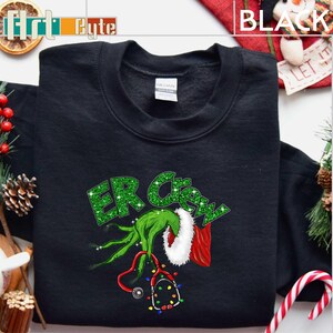 a black shirt with a green grin on it