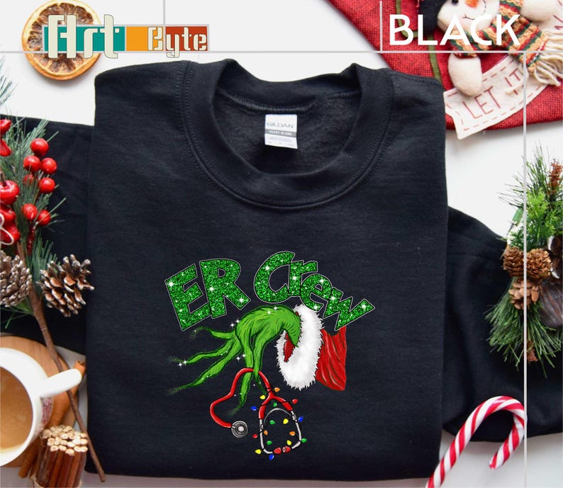 a black shirt with a green grin on it