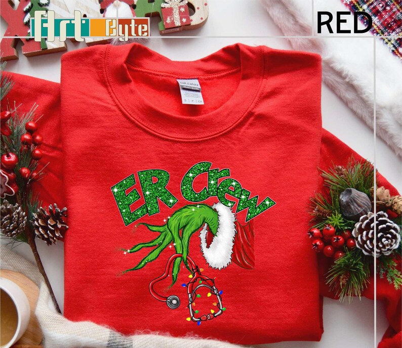a red t - shirt with the grin on it