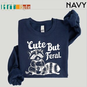 a navy blue shirt with a raccoon on it
