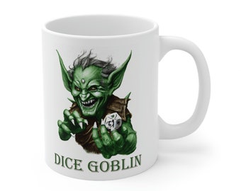 May include: White ceramic mug with a green goblin illustration holding a dice. The text "DICE GOBLIN" is printed below the goblin.
