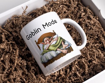 May include: White ceramic mug with a goblin sleeping in bed illustration and the text "Goblin Mode" printed on the front.