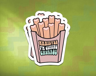 May include: A stack of stickers featuring a pink box of churros with heart-shaped ends. The text on the box reads "WHATEVER I'M GETTING CHURROS" in a retro font. The background is a textured green.