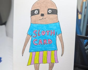 May include: A hand-drawn illustration of a brown sloth wearing a blue shirt with the words "Sloth Card" in pink and yellow letters. The sloth is wearing a pink and yellow striped skirt.
