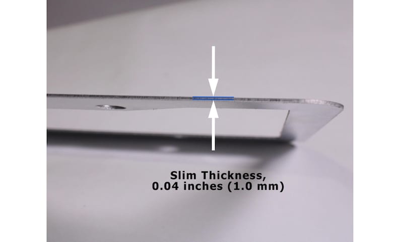 May include: A silver-colored metal frame with a slim thickness of 0.04 inches. The image features two white arrows pointing toward the edge of the frame, highlighting the measurement text Slim Thickness, 0.04 inches (1.0 mm) below the object.
