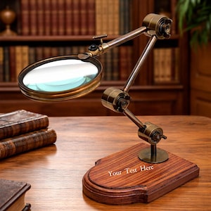May include: A vintage-style magnifying glass with a brass frame and adjustable arm, mounted on a wooden base. The base is engraved with the text "Your Test Here". The magnifying glass is set against a backdrop of antique books.