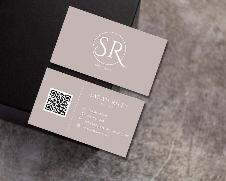 May include: A beige business card with a white circle containing the letters "SR" and the text "SARAH RILEY" below. The card also includes contact information, a QR code, and a website address.