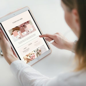 May include: A person using a tablet with a stylus. The tablet displays a branding guide with a logo placeholder, colour palettes, and font examples. The colour scheme includes shades of pink and brown, with floral imagery.