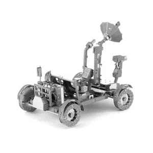 May include: A silver metal model of a lunar rover, with detailed construction including wheels, a satellite dish, and mechanical parts. The model has intricate cutouts and a textured surface, demonstrating a complex and realistic design. The rover is a miniature replica.