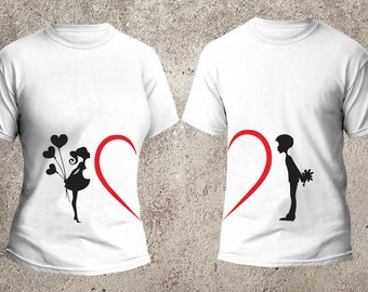 May include: Two white t-shirts with a red heart design. One shirt features a silhouette of a girl holding balloons, the other features a silhouette of a boy holding a flower.