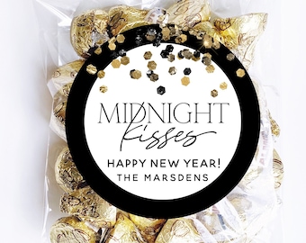 May include: A clear cellophane bag filled with gold foil-wrapped chocolate candies. A round black and white sticker with gold confetti reads "Midnight Kisses Happy New Year! The Marsdens."
