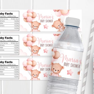 May include: Three pink and white water bottle labels with a teddy bear holding pink balloons and stars. The labels say "Maria's Baby Shower".