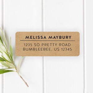 May include: A brown paper address label with the text "Melissa Maybury", "1235 So Pretty Road", and "Bumblebee, US 12345".
