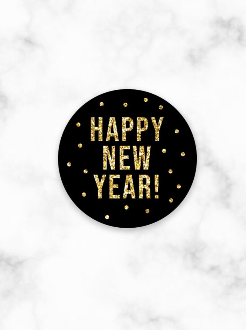 May include: Black circle with gold glitter text that reads "Happy New Year!" on a white marble background.
