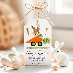 May include: A white gift tag with a cartoon bunny rabbit driving a carrot. The tag has the text "Happy Easter! I'm so hoppy to be your friend. Love, Carter."