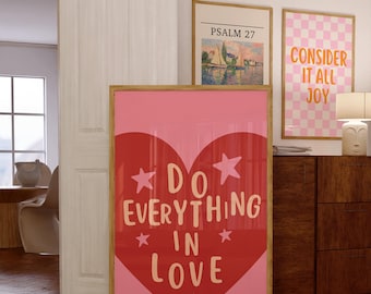 May include: A pink and red framed poster with a large heart shape and the text "Do Everything In Love" with white stars around the text.