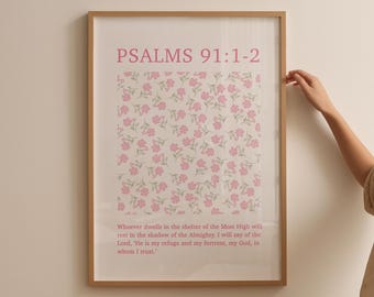 May include: A framed print with a floral pattern and the text "PSALMS 91:1-2" in pink. The text below the floral pattern reads "Whoever dwells in the shelter of the Most High will rest in the shadow of the Almighty. I will say of the Lord, "He is my refuge and my fortress, my God, in whom I trust."