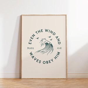 May include: A framed print with a beige background and a circular design in teal. The design features a stylized wave, three birds, and the text "Even the wind and waves obey Him" with "Mark 4:41". The frame is a light brown color.