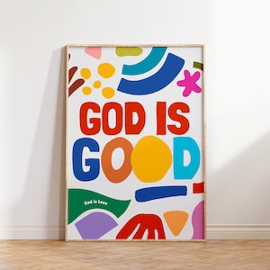 May include: A colourful poster with the text "God is Good" in large, bold letters. The poster features a variety of abstract shapes in bright colours, including red, yellow, blue, green, and purple. The text "God is Love" appears in smaller letters at the bottom of the poster.