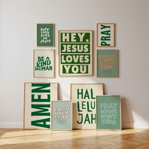 May include: A collection of framed art prints with inspirational quotes. The prints feature phrases like "Hey Jesus Loves You," "Be a Kind Human," and "Pray." The color palette includes green, beige, and gold frames, creating a cohesive aesthetic.
