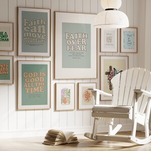 May include: A white rocking chair sits in front of a wall with framed prints featuring inspirational quotes and scripture verses. The prints have a light green background with colorful text. The quotes include "Faith can move mountains", "Faith over fear", "Love like Jesus", "God is good all the time", "Be a kind human", and "Trust in the Lord".