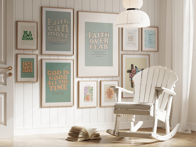 May include: A white rocking chair sits in front of a wall with framed prints featuring inspirational quotes and scripture verses. The prints have a light green background with colorful text. The quotes include "Faith can move mountains", "Faith over fear", "Love like Jesus", "God is good all the time", "Be a kind human", and "Trust in the Lord".